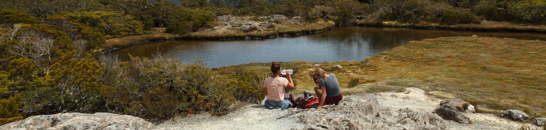 Hikers taking a break and enjoying the alpine scenery.