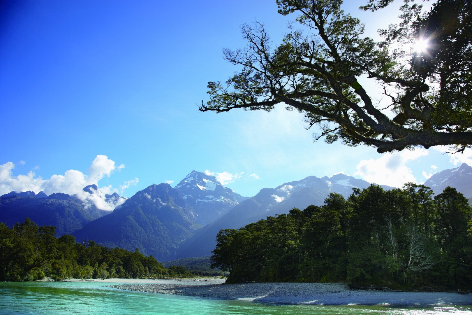 Turquoise Upper Hollyford River with Darran Mountains in the back.