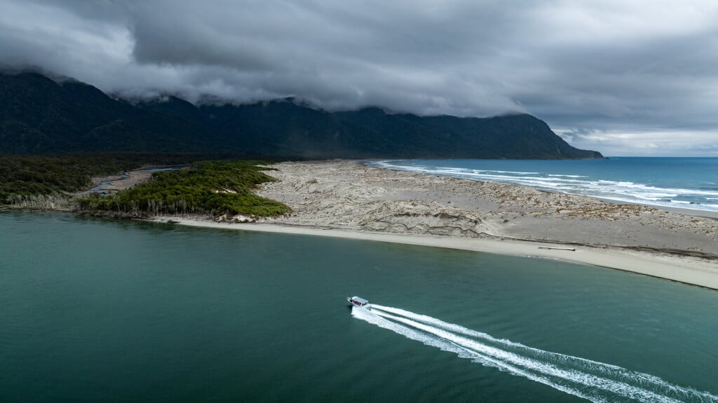 Crossing the Hollyford to explore its wild southern shore.