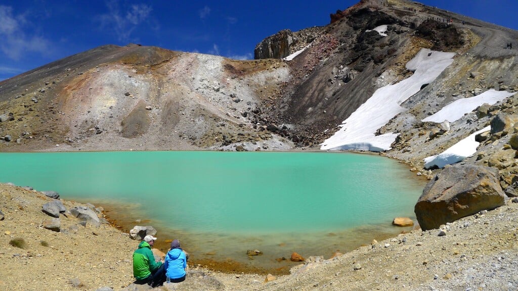 Resting beside Tongariro Alpine Crossing's stunning Emerald Lakes
