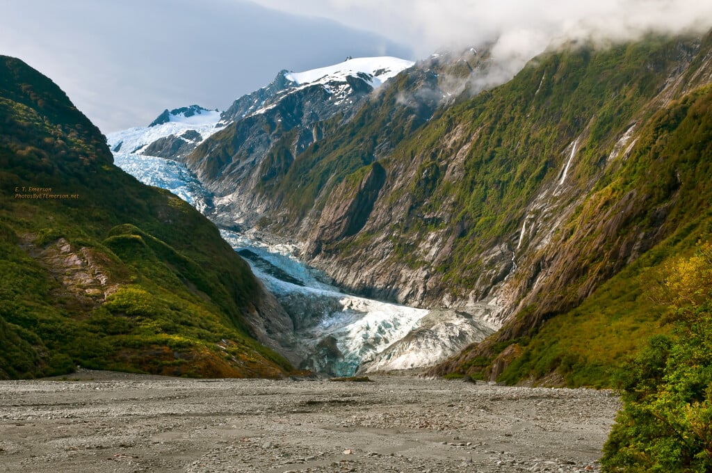 The Fox and Franz Josef Glaciers descend from the Southern Alps ice plateau into temperate rainforest, a contrast found nearly nowhere else on Earth.