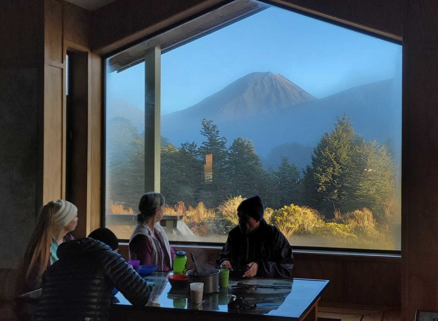 A quiet moment at the hut window after a day on the trail, watching the weather roll over Mt Ngauruhoe.